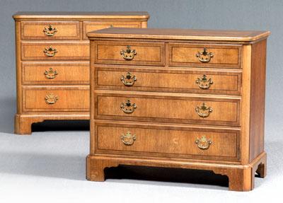 Appraisal: Pair Baker bachelor's chests Chippendale style oak veneer two over