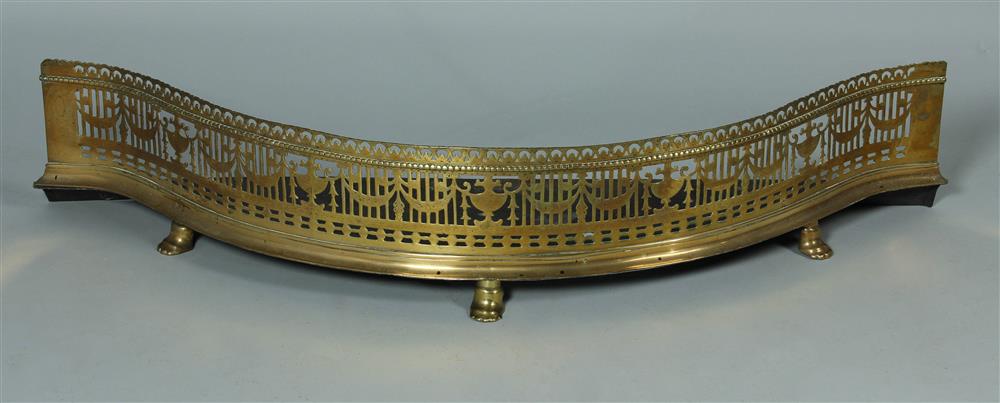 Appraisal: NEOCLASSICAL BRASS AND IRON SERPENTINE FENDER the pierced brass serpentine