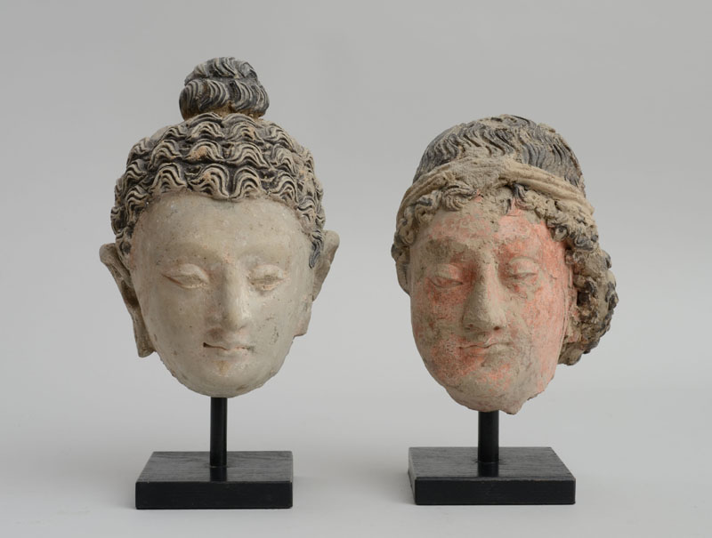 Appraisal: GANDHARAN POLYCHROME CLAY HEAD OF BUDDHA AND ANOTHER OF A