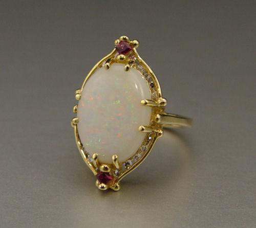 Appraisal: OPAL AND DIAMOND RING K yellow gold ring contains one