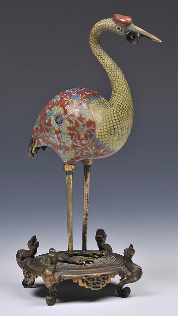 Appraisal: A CLOISONNE MODEL OF A STORK holding a flower in