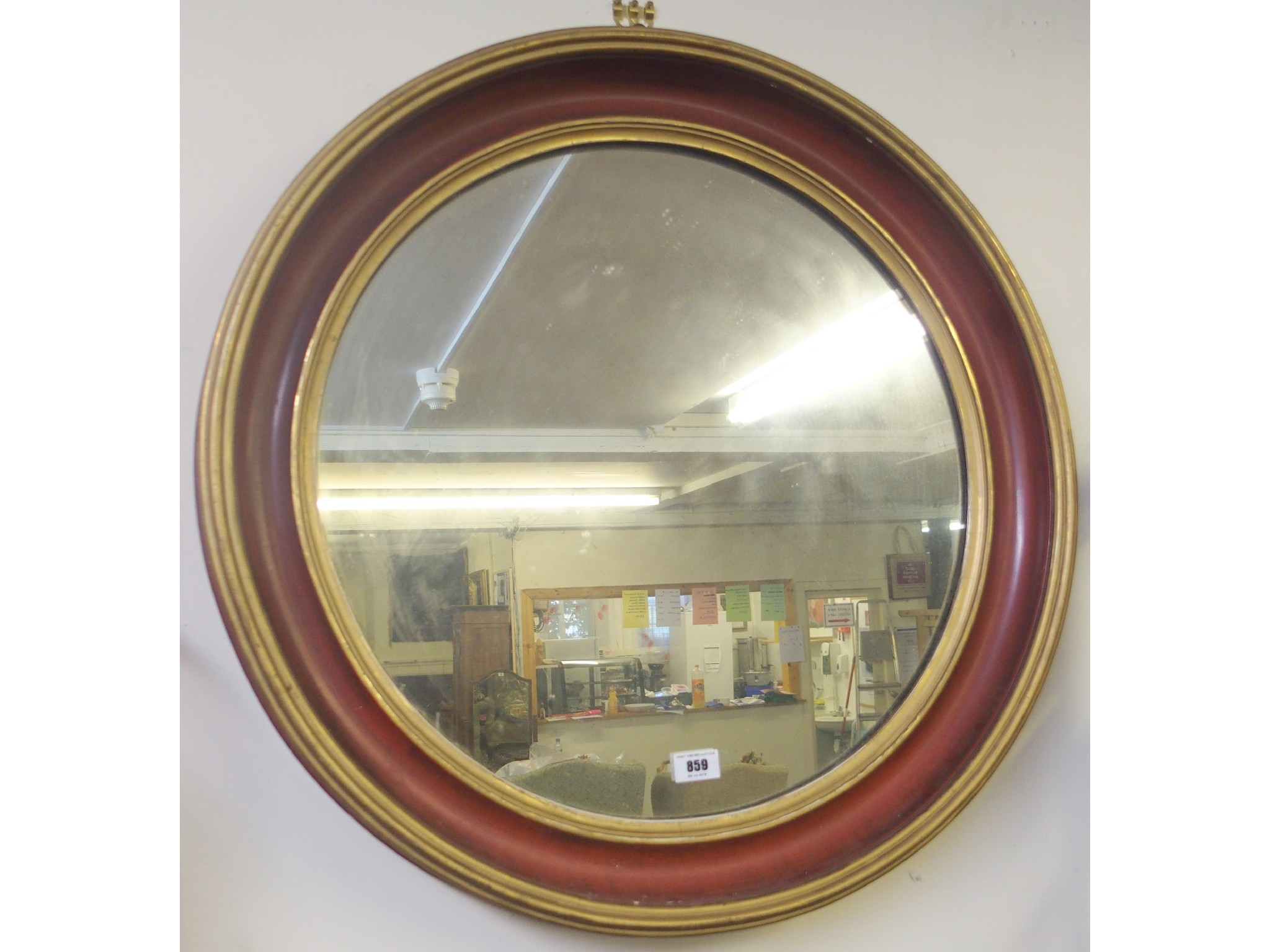 Appraisal: A gilt and red circular mirror