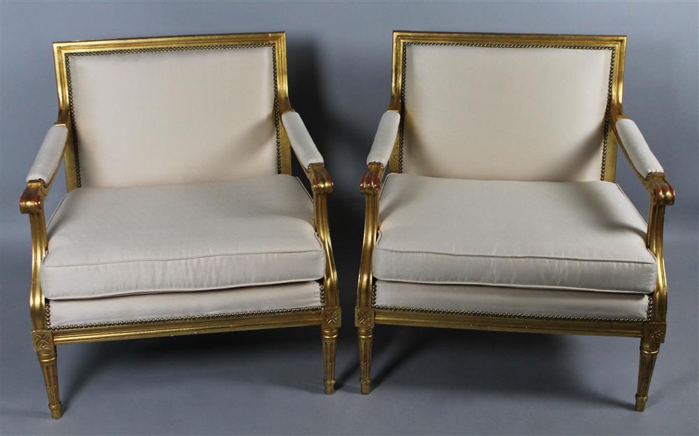 Appraisal: PAIR OF GILT AND WHITE UPHOLSTERED LOUIS XVI STYLE FAUTEUILS