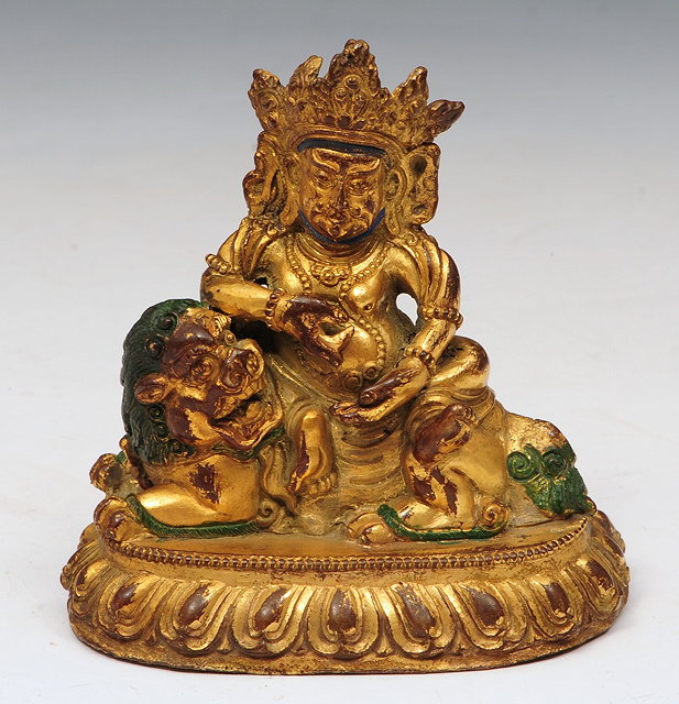 Appraisal: A SINO TIBETAN GILT BRONZE DEITY seated on a lion