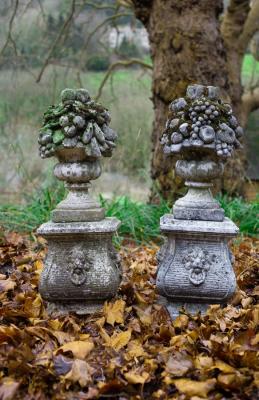 Appraisal: A pair of reconstituted stone garden ornaments modelled as vases