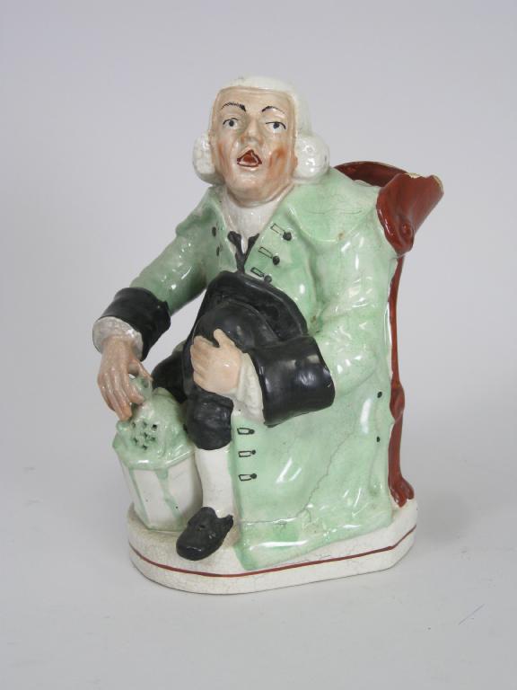 Appraisal: A Staffordshire Jug in the form of a seated figure