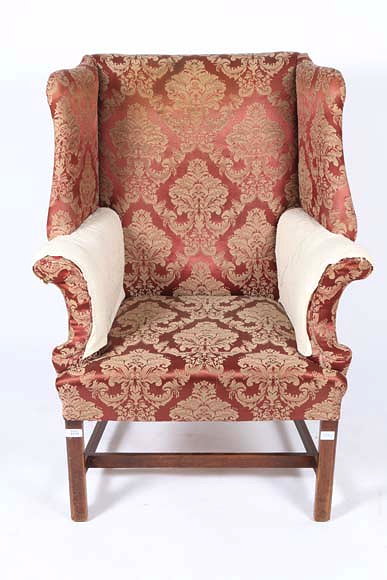 Appraisal: A GEORGIAN STYLE WING BACK ARMCHAIR on square mahogany legs