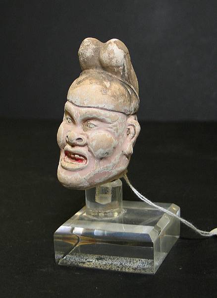 Appraisal: A painted pottery head from a mortuary figure Tang Dynasty