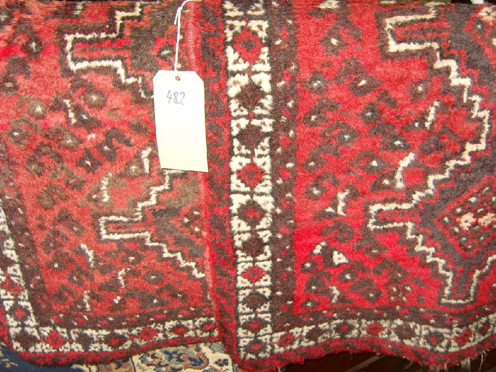 Appraisal: A pair of small red ground eastern wool rugs with