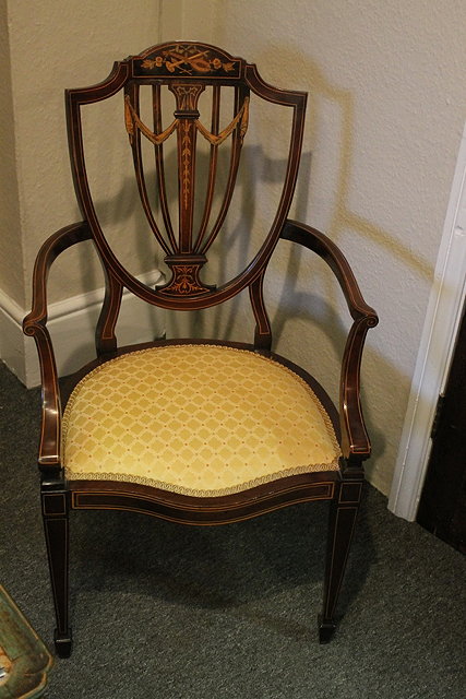 Appraisal: AN EDWARDIAN MAHOGANY AND SATINWOOD INLAID ELBOW CHAIR with shield