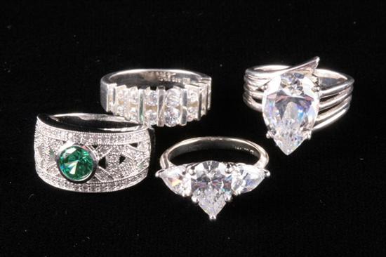 Appraisal: FOUR SILVER-MOUNTED AND FAUX DIAMOND RINGS Sizes and