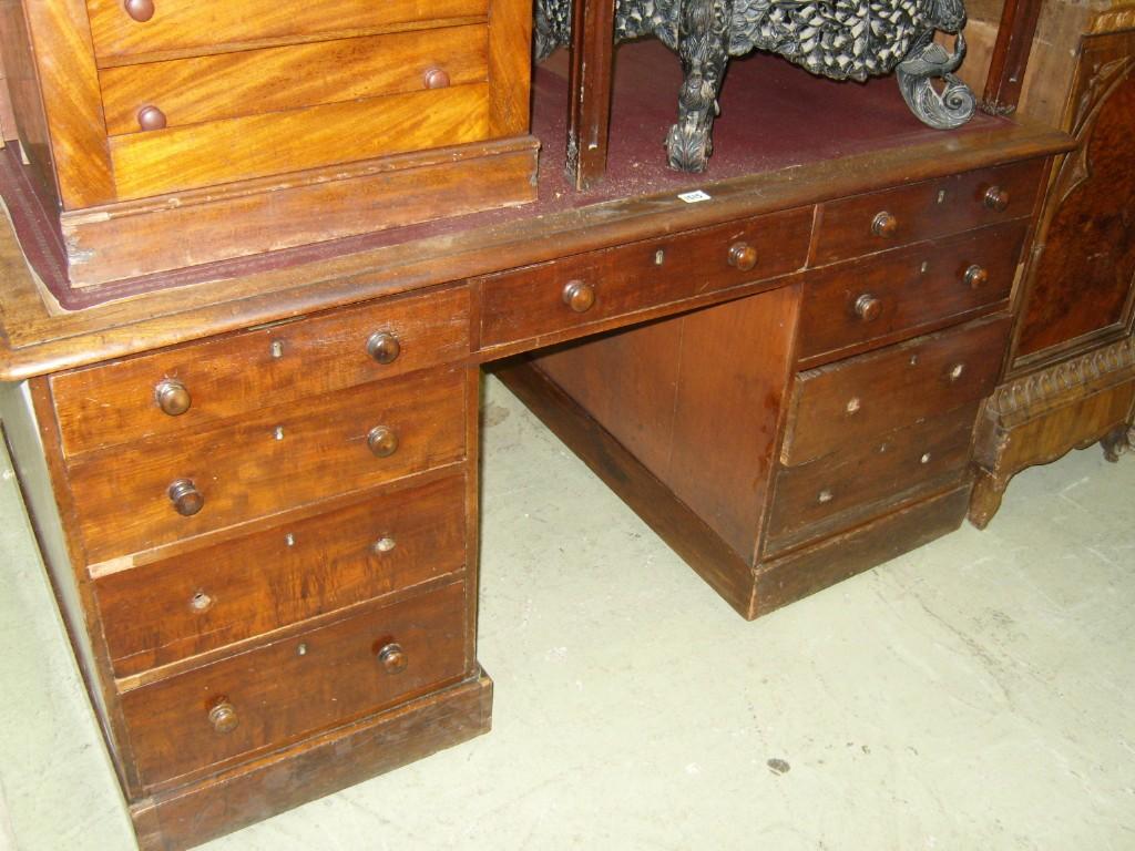 Appraisal: A Victorian mahogany kneehole partners desk one side fitted with