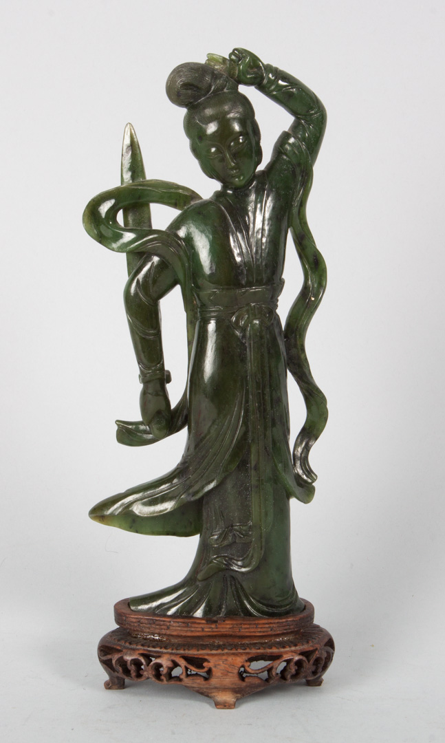 Appraisal: Chinese carved jade female guardian modeled as exotic female holding