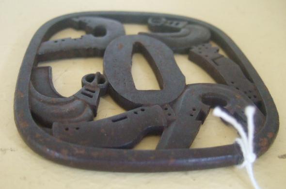 Appraisal: An iron tsuba of rounded square form pierced with stirrups