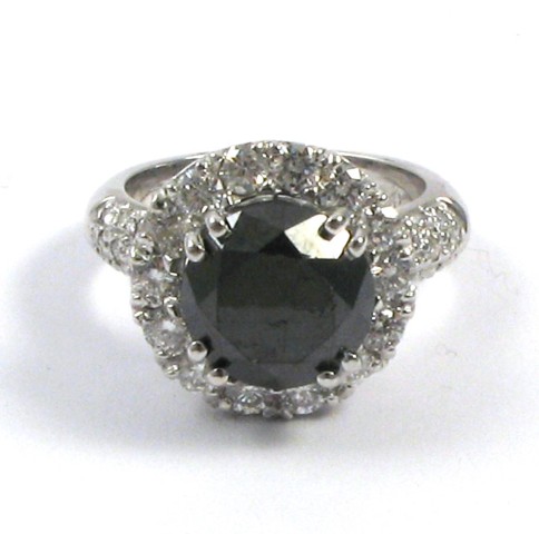 Appraisal: BLACK DIAMOND AND FOURTEEN KARAT GOLD RING centering a round