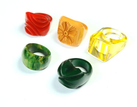 Appraisal: FIVE EARLY PLASTIC RINGS American Ca - Red carved ring