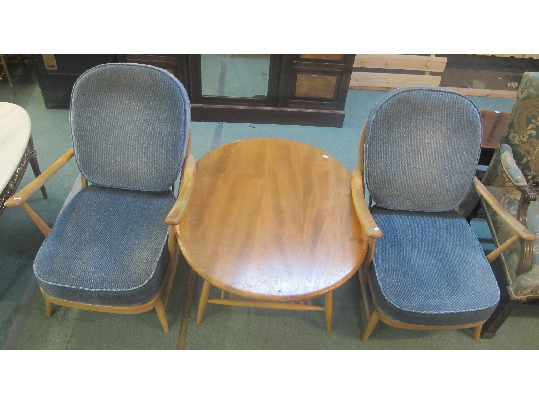 Appraisal: A pair of blonde Ercol armchairs and a coffee table