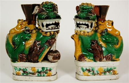 Appraisal: A pair of Chinese pottery lion dog incense burners each