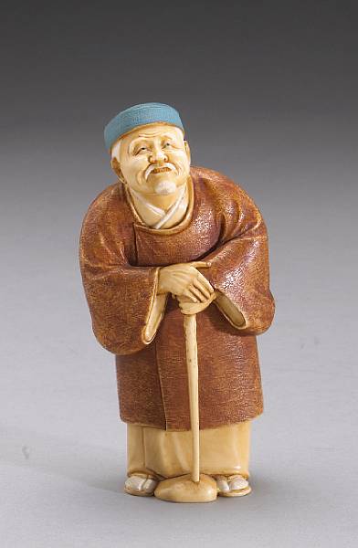 Appraisal: A tinted ivory figural okimono th Century Expertly carved and