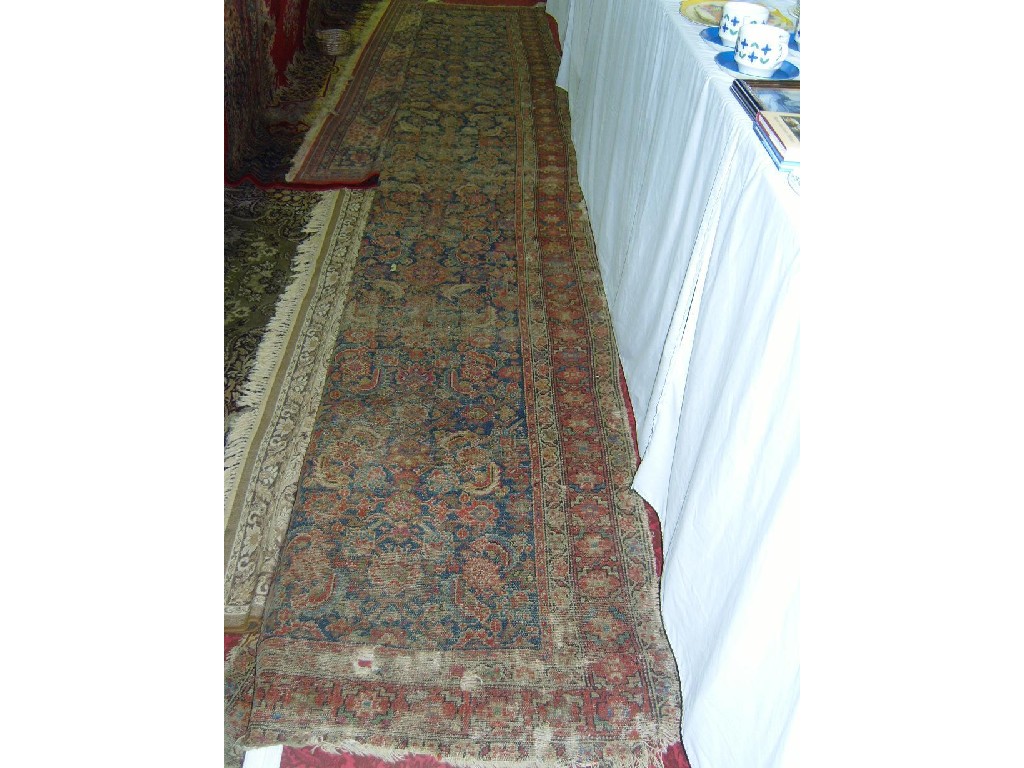 Appraisal: An eastern wool runner with stylised floral decoration in red