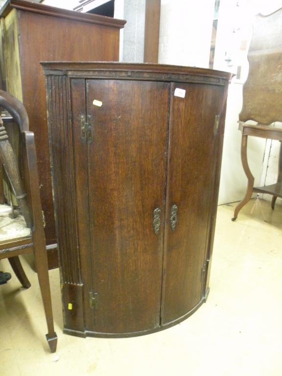 Appraisal: A George III mahogany bow front corner cabinet with two