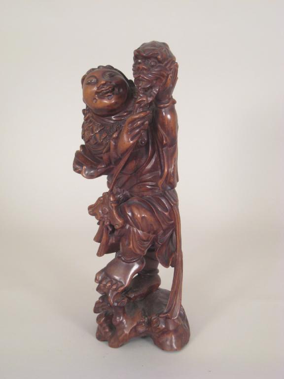 Appraisal: A Japanese carved hardwood Standing Figure with a kylin in