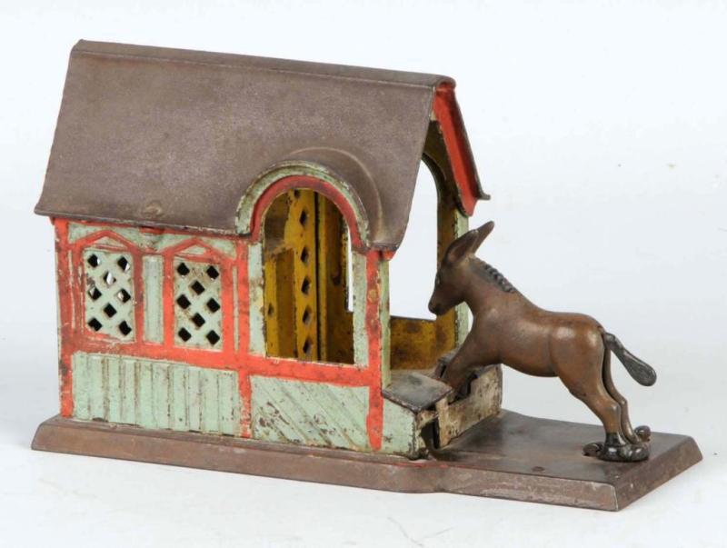 Appraisal: Cast Iron Mule Entering Barn Mechanical Bank Description Manufactured by