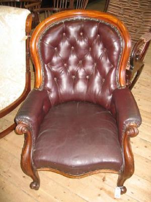 Appraisal: A VICTORIAN WALNUT FRAMED ARMCHAIR of spoonback type button upholstered