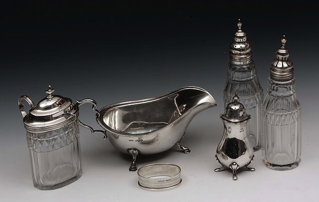 Appraisal: A SILVER SAUCE BOAT with gadrooned edge three cabriole legs