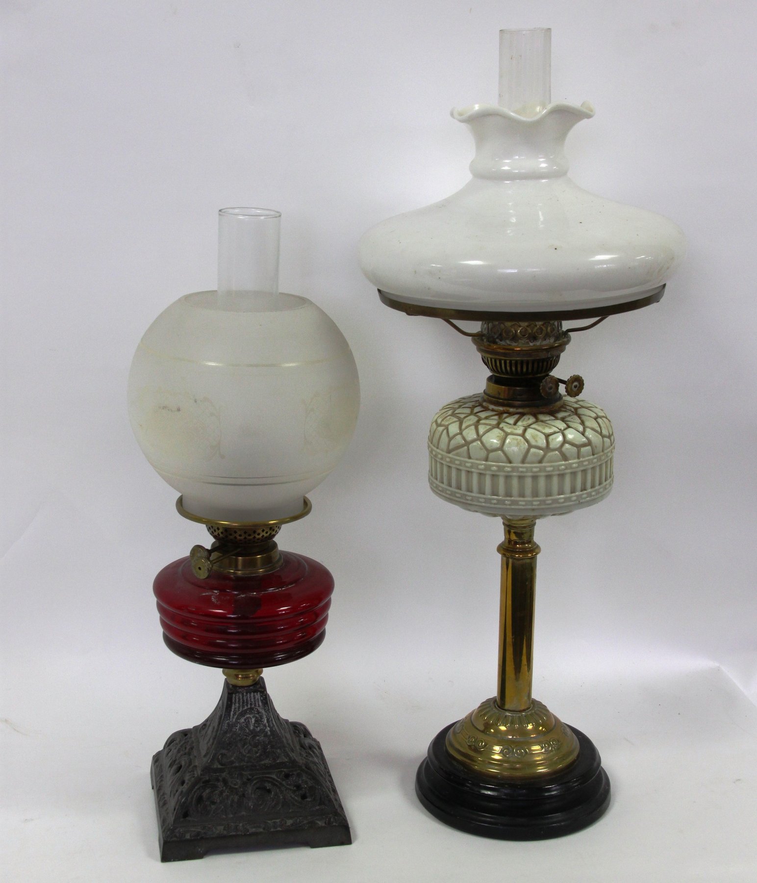 Appraisal: An oil lamp with opaque glass shade and reservoir on