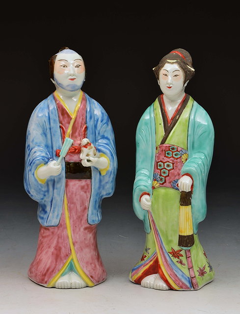 Appraisal: Pair of Japanese Kutani figuresgentleman holding a small puppy and