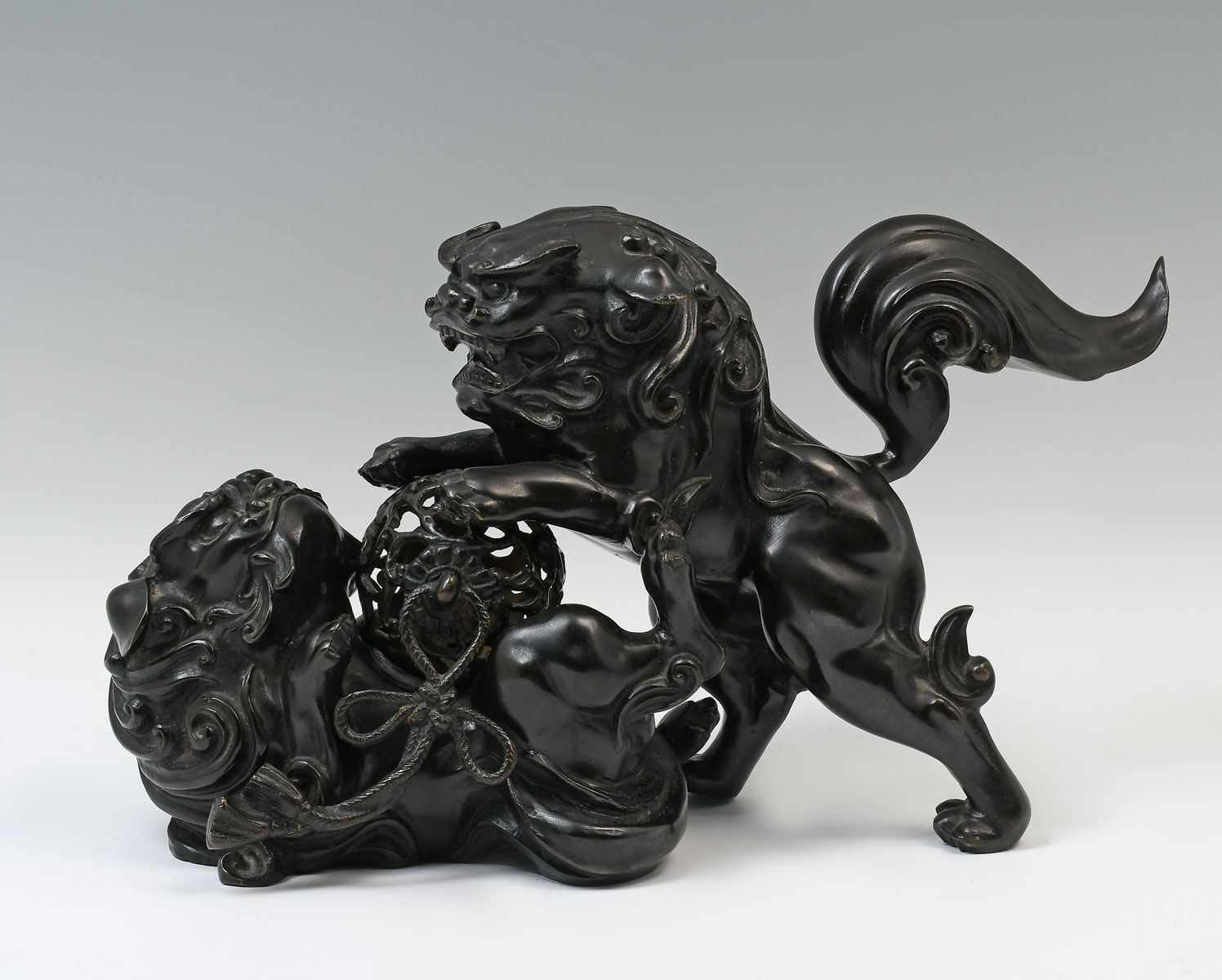 Appraisal: BRONZE CHINESE FOO DOGS WITH PUZZLE BALL - Patinated bronze