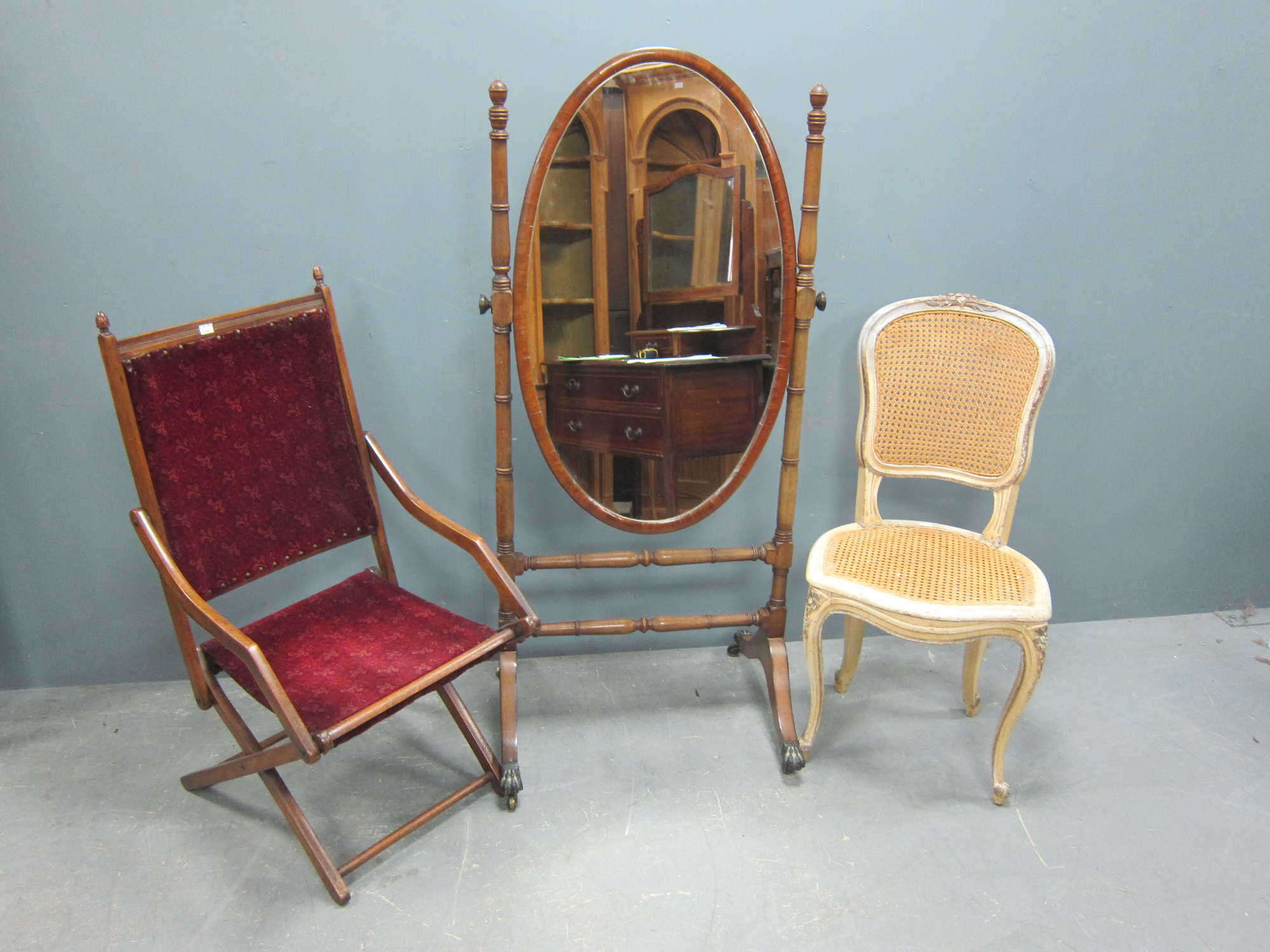 Appraisal: Mahogany oval cheval mirror with turned supports and splayed legs