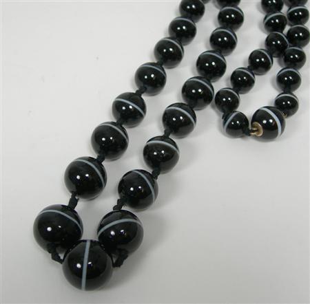 Appraisal: An Edwardian sard onyx bead necklace composed of graduated spherical