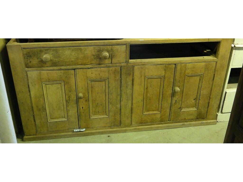 Appraisal: A stripped pine dresser base enclosed by two pairs of