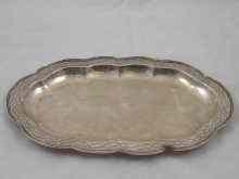 Appraisal: An oval silver dish with lobed rim and wrigglework border