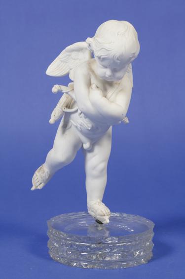 Appraisal: A PARIAN WARE MODEL OF AN ICE-SKATING CUPID on a