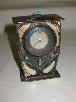 Appraisal: AN ARTS AND CRAFTS MANTEL CLOCK the French movement having