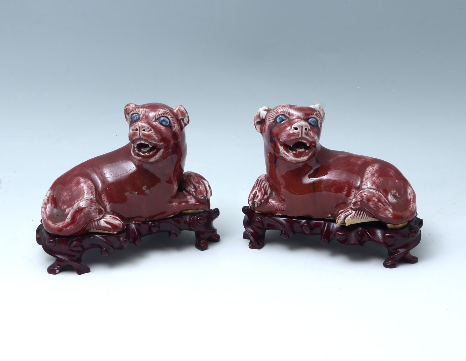 Appraisal: PAIR CHINESE OX BLOOD GLAZED RESTING FOO DOGS - Chinese