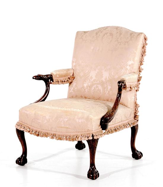 Appraisal: Chippendale style carved mahogany library chair th century serpentine padded