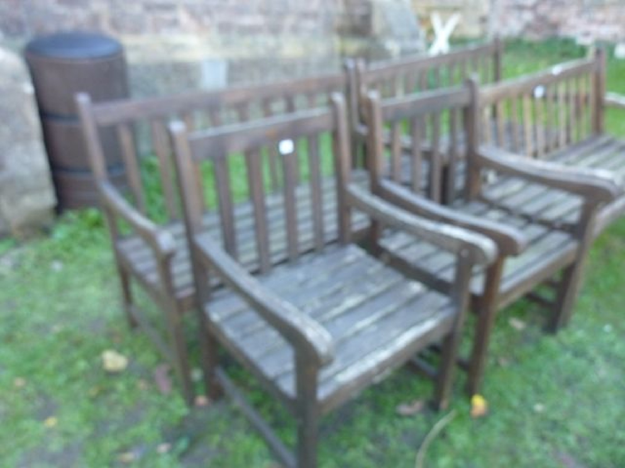 Appraisal: A contemporary stained hardwood two seat garden bench with slatted