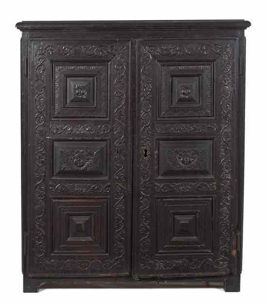 Appraisal: A Continental Carved Oak Cabinet the rectangular top over two