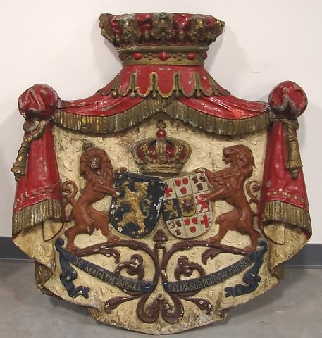 Appraisal: Relief painted decorated metal plaque with pair of lions supporting