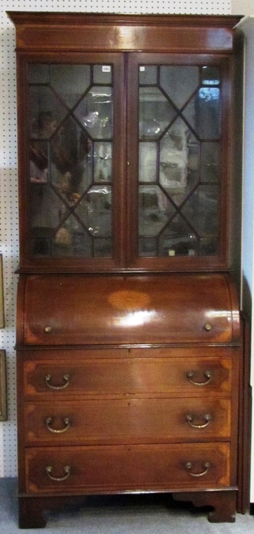 Appraisal: A th century marquetry inlaid mahogany cylinder bureau bookcase on