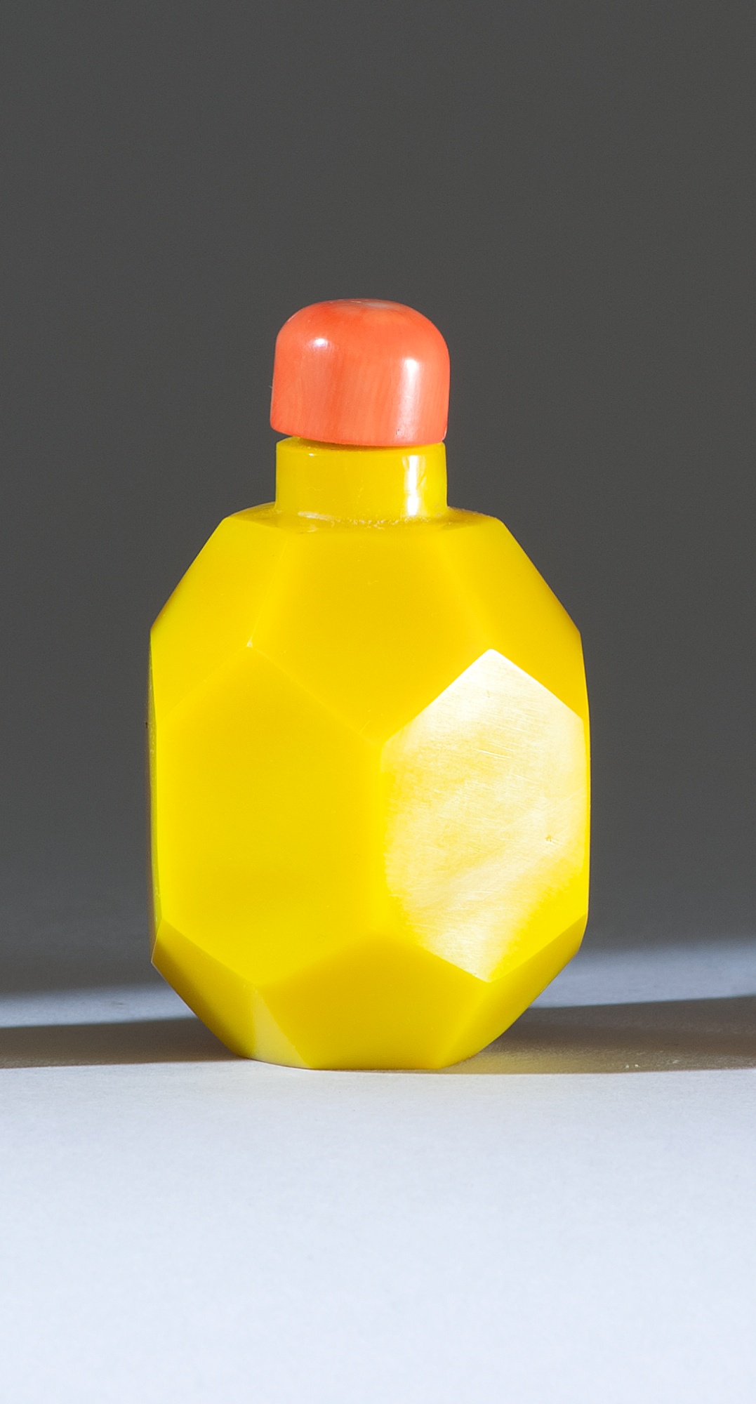 Appraisal: FACETED GLASS SNUFF BOTTLE Late th CenturyIn Imperial yellow Height