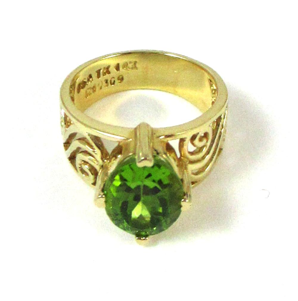 Appraisal: PERIDOT AND FOURTEEN KARAT GOLD RING with four yellow gold