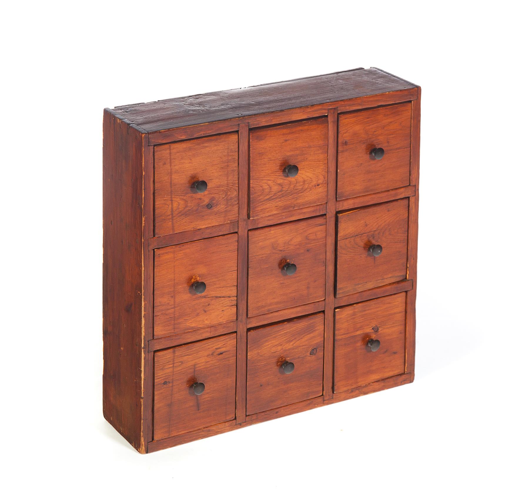 Appraisal: NINE-DRAWER APOTHECARY Nineteenth century Pine with square nailed drawers refinished