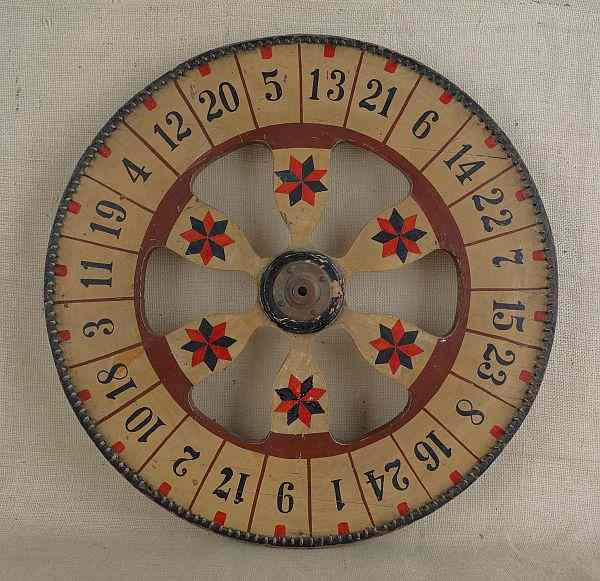 Appraisal: Painted double-sided gaming wheel late th c dia