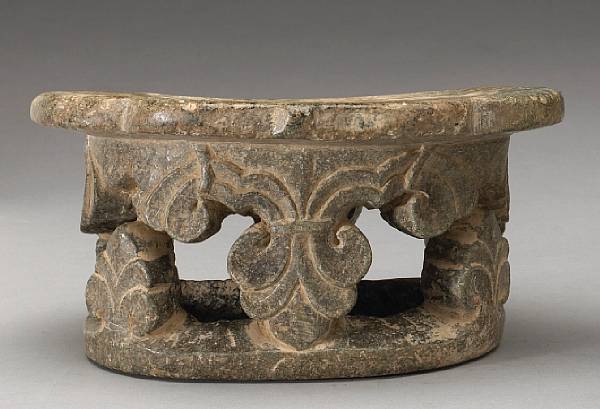 Appraisal: A rare carved stone pillow The ruyi shaped head rest