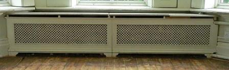 Appraisal: A double pierced cast radiator surround with marble top on